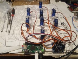 8 servomotors connected to a controller board and a raspberry pi- steampunk tentacle hat by Derek Woodroffe