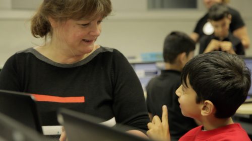 A boy learning about computing from a woman - Royal Society After the Reboot