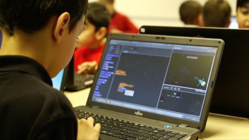 A child coding in Scratch on a laptop - Royal Society After the Reboot