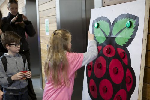 Raspberry Pi button Carrie Anne Philbin A girl plays a button reaction game at a Raspberry Pi event