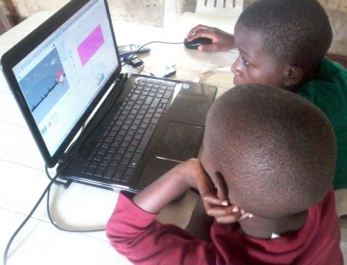 Two boys at a laptop. Joel Bayubasire CoderDojo — 2000 Dojos