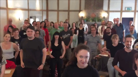 A GIF showing lots of Raspberry Pi colleagues smiling, saluting and clapping enthusiastically