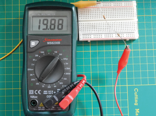 A multimeter showing the figure 19.88 with a resistor connected via crocodile clips