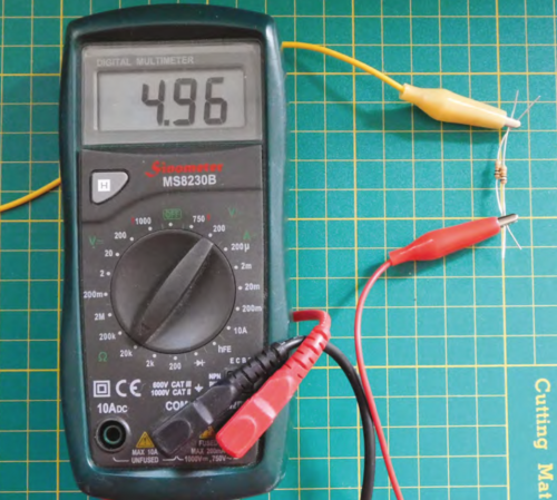 A multimeter showing the figure 4.96 with a resistor connected via crocodile clips