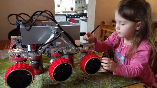 A young girl inspects the Yuri 3 Mars rover