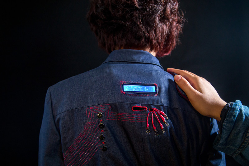 Tap the shoulder pad to follow the wearer; follow numbers are shown on the LCD