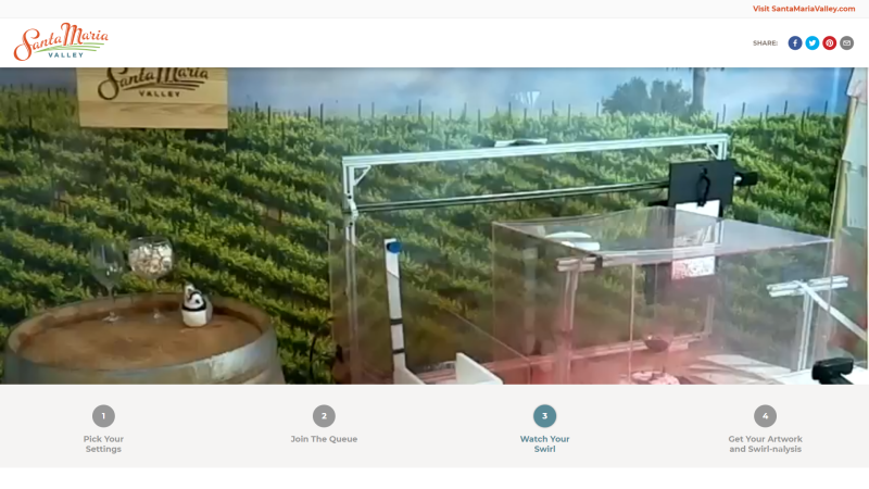 A gripper arm grabs and positions the paper before wine is dispensed, the glass is spun and art happens.