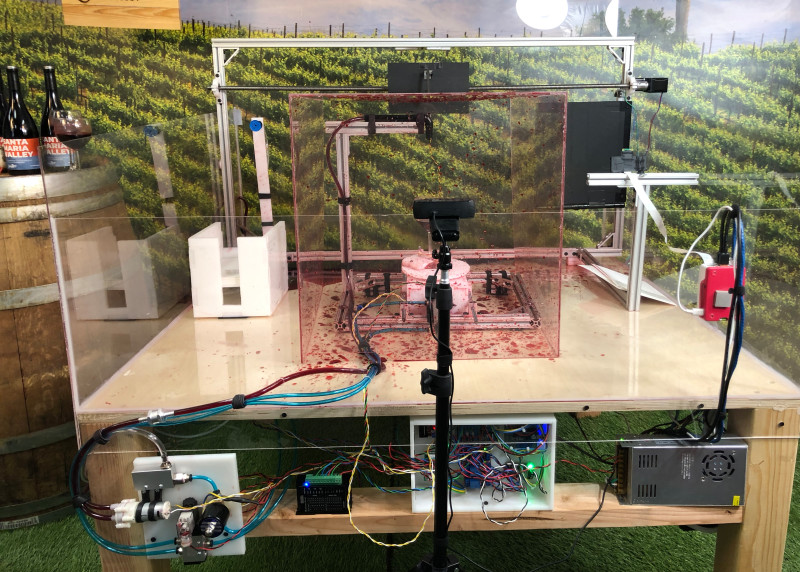 A robot arm grabs paper and moves it along the swirl production line. Arduinos control the wine glass, and a spinning plate swirls the glass. 