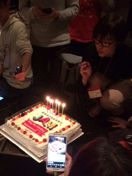 Someone blowing out the candles of a birthday cake