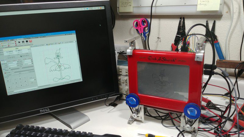 A standard Etch-A-Sketch toy is able to display whatever image is outputted via the bCNC program installed on Raspberry Pi