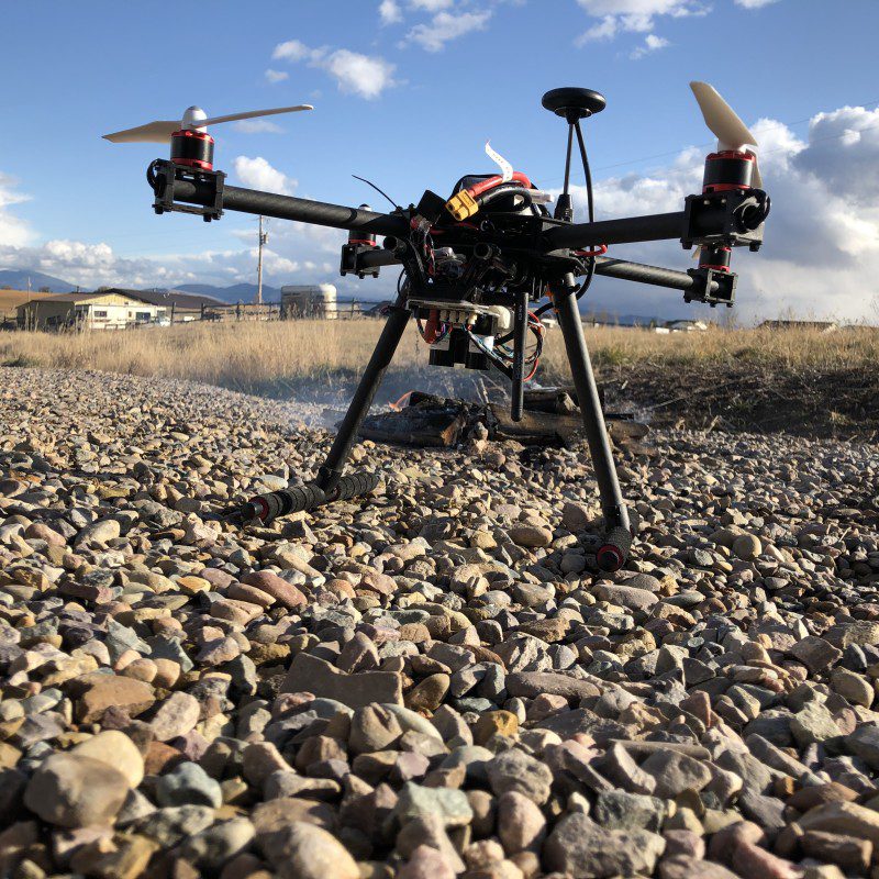 Preparing for take-off, the Hot Spotter drone is pictured in front of a charcoal fire used for testing purposes