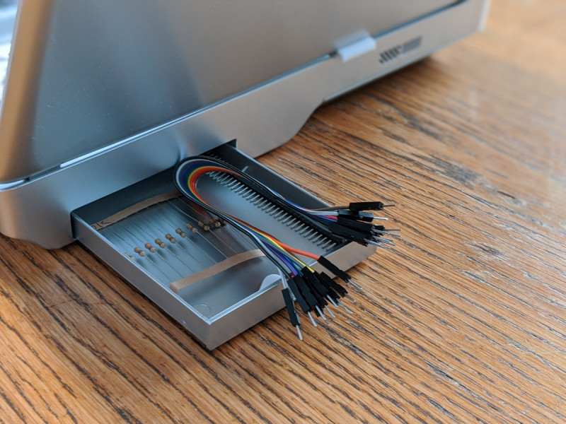 A storage box on the rear of the laptop is used for accessories or to add a power bank for using the laptop on the move