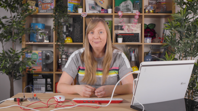 Carrie Anne Philbin MBE sitting at a disk with physical computing equipment