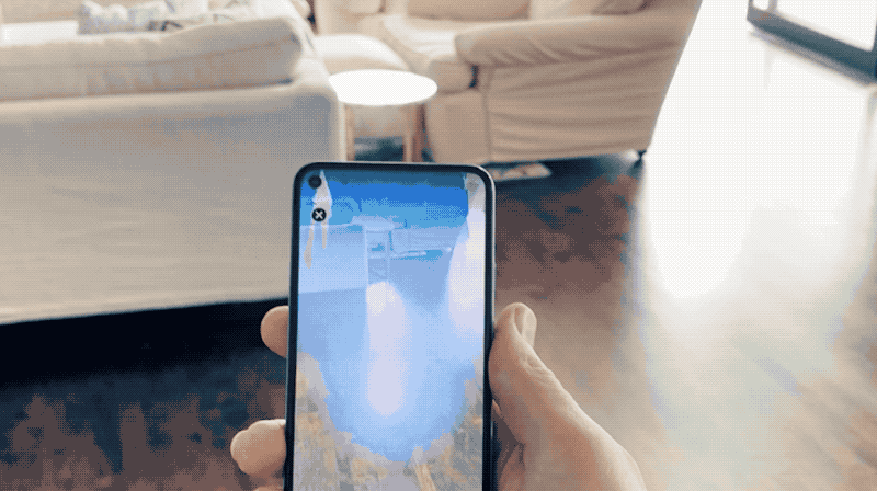 Animated GIF showing a person's hand holding a Pixel phone while using the Mandalorian AR app.