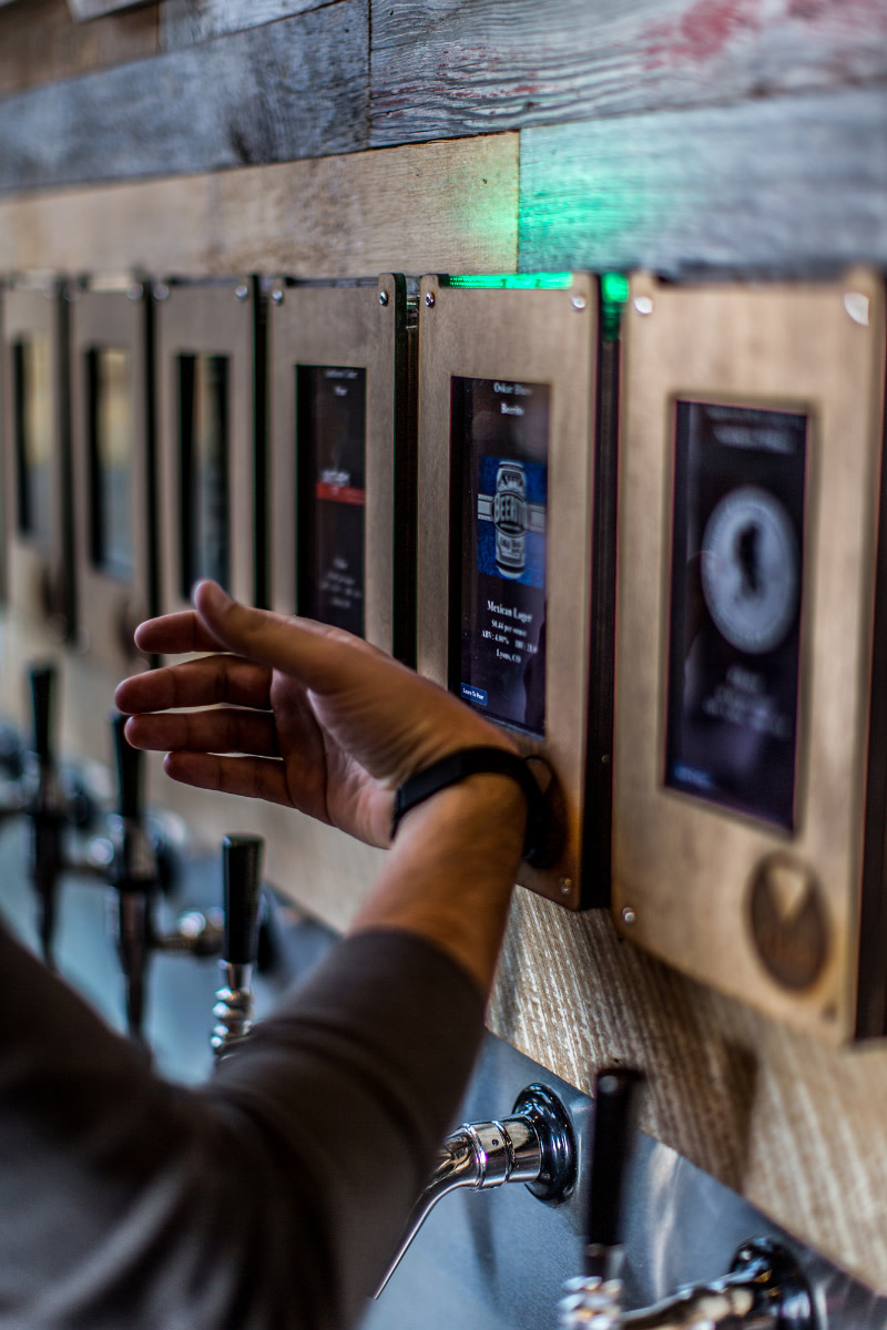The customer's drinks tab is set up when they arrive and links to an RFID wristband that activates the dispensers at the beer wall