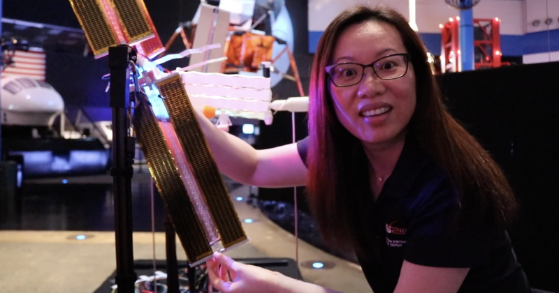 A member of team ISS Mimic showing off a solar panel