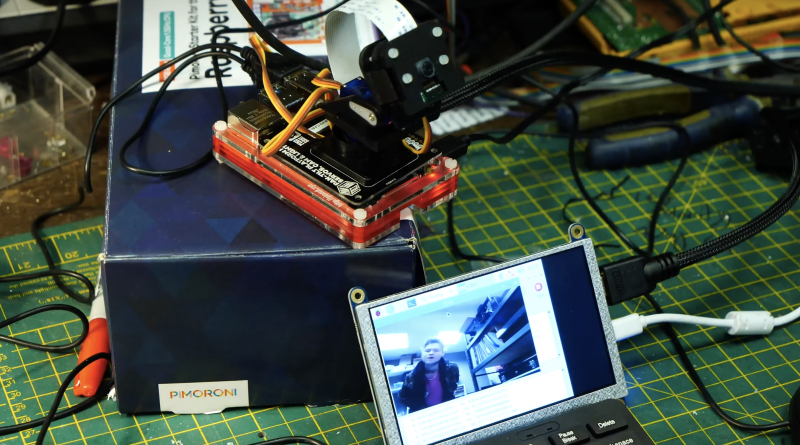 face recognition software running on small screen with raspberry pi camera behind it, looking at the maker