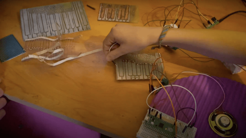 kids hands showing the pieces of the pico piano