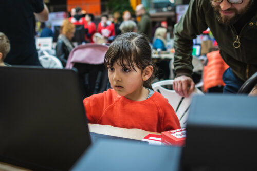 A young girl uses a computer.