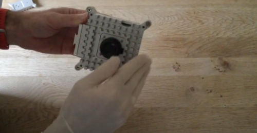 Testing the new Raspberry Pi-powered Astro Pi units for sharp edges using a latex glove.
