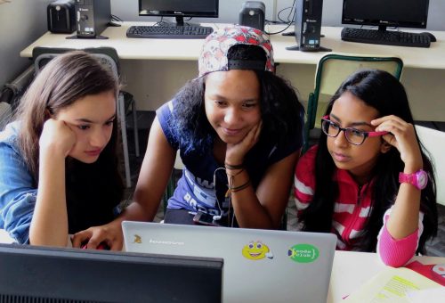 Three teenage girls at a laptop.
