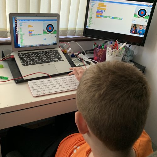 a sighted boy using Scratch on a laptop at home